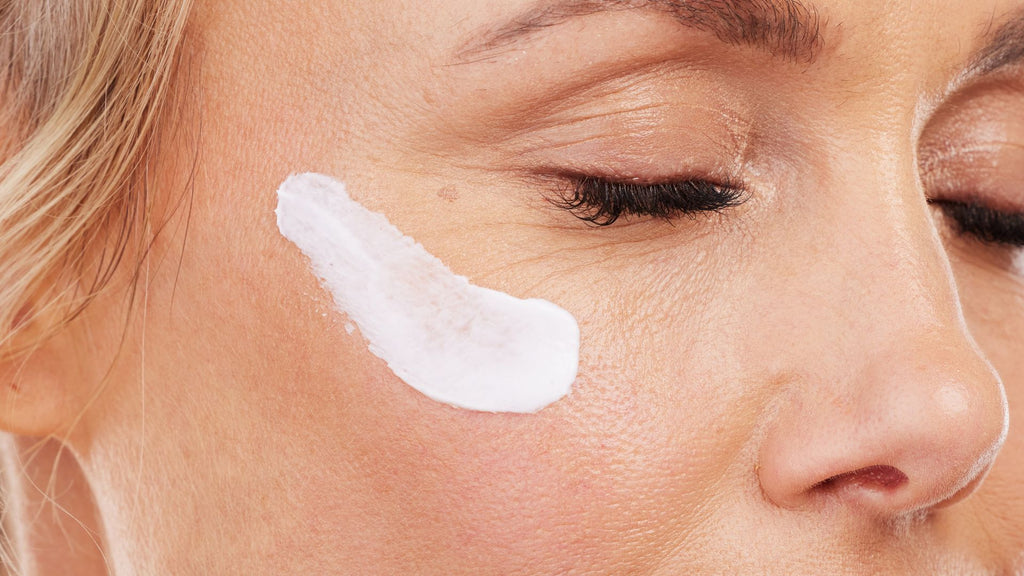 Woman using Tailor Restore night balm made with red seaweed