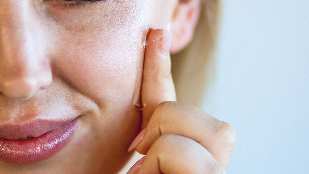 Woman Applying Hyaluronic Acid Serum To Dry Skin on Face