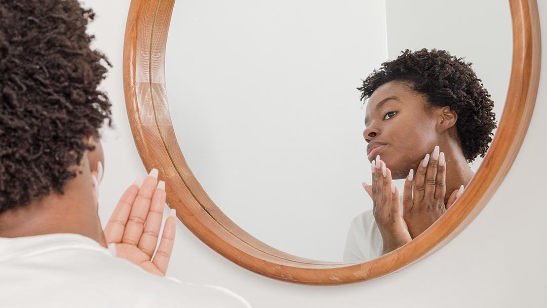 Woman Applying Silicone Free Natural Moisturiser to Face